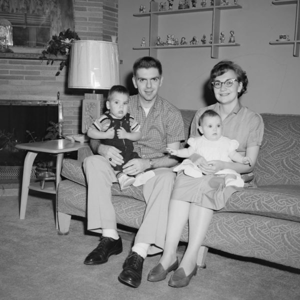 grayscale photo of 2 boys sitting on couch